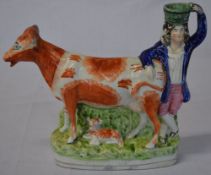 Staffordshire flatback spill vase of a gentleman & a cow