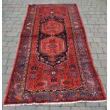 Persian handwoven red ground runner