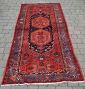 Persian handwoven red ground runner