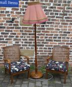Pair of bergere chairs with modern material covers and a standard lamp