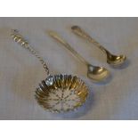 Silver strainer spoon and two small silver condiment spoons, total approx weight 0.