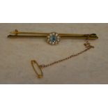 9ct gold bar brooch with safety chain, set with seed pearls and a blue glass stone,