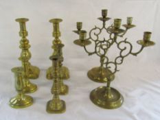 Selection of brass candlesticks and candelabras