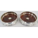 Pair of silver wine coasters with wooden bases London 1998 D 12.