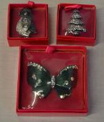 2 Butler And Wilson brooches of a penguin and a Christmas tree and a Butler And Wilson butterfly