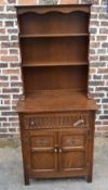 Oak carved bookcase on cabinet