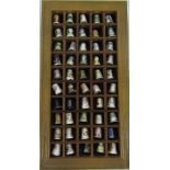 Wooden wall display containing 50 ceramic thimbles inc Royal Worcester,