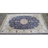 Large blue ground rug with central medallion design,
