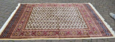 Large ivory ground rug with an all over design,