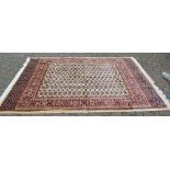 Large ivory ground rug with an all over design,