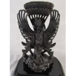 Large glass dome containing carved Balinese ebony deity Vishnu riding on Garuda (height of figure