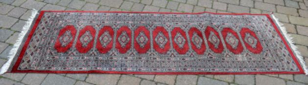 Persian style runner with a repeating central medallion design,