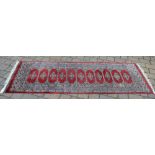 Persian style runner with a repeating central medallion design,