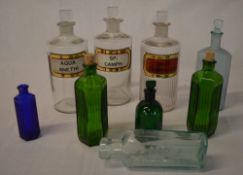 Various vintage pharmacy bottles including Aqua Anethi,