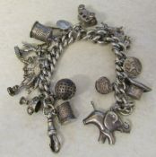 Sterling Silver charm bracelet with silver and white metal charms total weight 2.