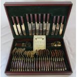Cased gold plated canteen of cutlery with wooden handles