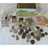 Tin containing various coins,