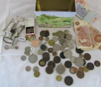 Tin containing various coins,