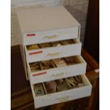 Four drawer modern watchmakers cabinet full of crystals for watch repair