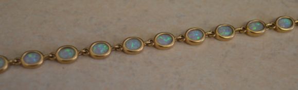 9ct gold bracelet set with created opals, total approx weight 10.