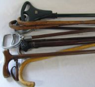 Assorted shooting sticks and walking sticks