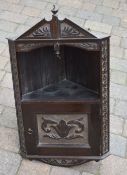 Small carved oak corner cupboard