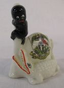 Arcadian crested china figure of a black boy being chased up a tree by an alligator