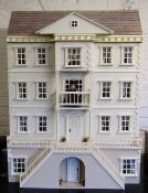 An impressive five storey Georgian style dolls house fitted for electricity complete with furniture,