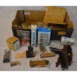 Various watchmakers repair tools including files, drill bits, small vice,