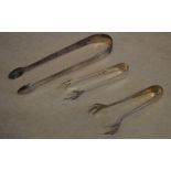 Pair of silver sugar tongs and two smaller pairs of sugar tongs, total approx weight 1.