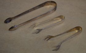 Pair of silver sugar tongs and two smaller pairs of sugar tongs, total approx weight 1.