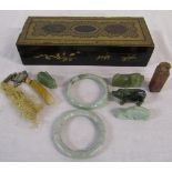 Lacquered box (af) containing assorted jade carvings and bangles etc
