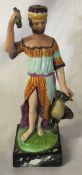 Staffordshire ceramic figure of a man holding a bundle of sticks next to an eagle on a marble