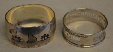 Foreign silver napkin ring decorated with niello shipping scenes and one other decorated with the