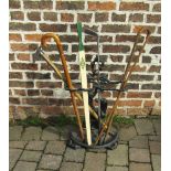 Cast iron stick stand with assorted sticks etc