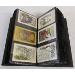 Postcard album of over 180 early and mid 20th century greetings cards inc c.