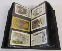 Postcard album of over 180 early and mid 20th century greetings cards inc c.