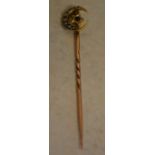 Yellow metal stick pin marked '18ct' to the top section decorated with seed pearl and a single