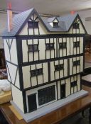 Large four storey Tudor style dolls house and shop fitted for electricity complete with furniture,