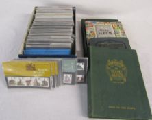 Approximately 180 British Post Office mint stamp issues and 4 empty stamp albums