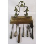 Set of brass troika bells & group of old cutlery inc silver butter/fish knife