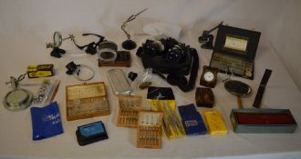 Quantity of watchmakers tools including various small desk vices with magnification, watch parts,