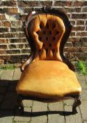 Victorian button back leather nursing chair with ball and claw feet