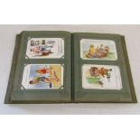 Postcard album containing approximately 170 Donald McGill comic postcards dating from early 1900s