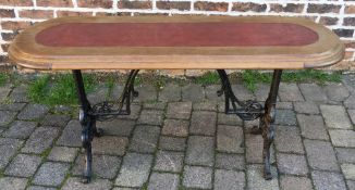 Ornate cast iron pub table with a wooden oval top L 136cm W 46cm