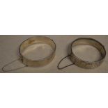 2 decorated silver bangles, both with safety chains, total approx weight 2.