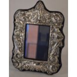 Ornate Britannia silver photo frame surrounded by repousse characters including a cavalier and
