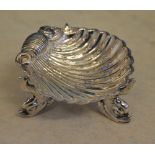 Small ornately decorated shell dish raised on three legs, each shaped as fish, Birmingham 1881,