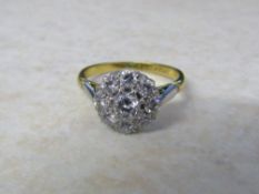 18ct gold and platinum diamond daisy ring (central stone 0.23 ct outer stones 0.40 ct total 0.