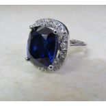 18ct white gold ring set with a single 11ct blue sapphire (13 x 11 x 7 mm) and approximately 1.